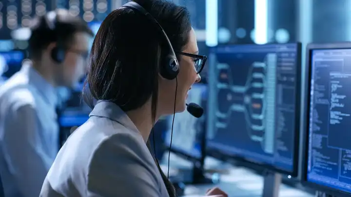 woman with headset at monitor